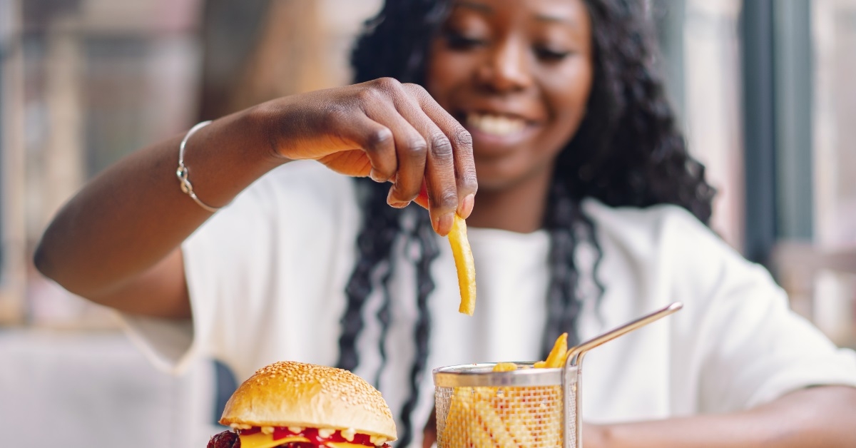 african american woman eating burger