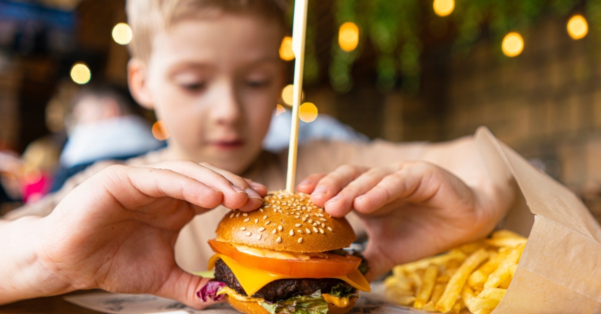 child eating mini cheese burger
