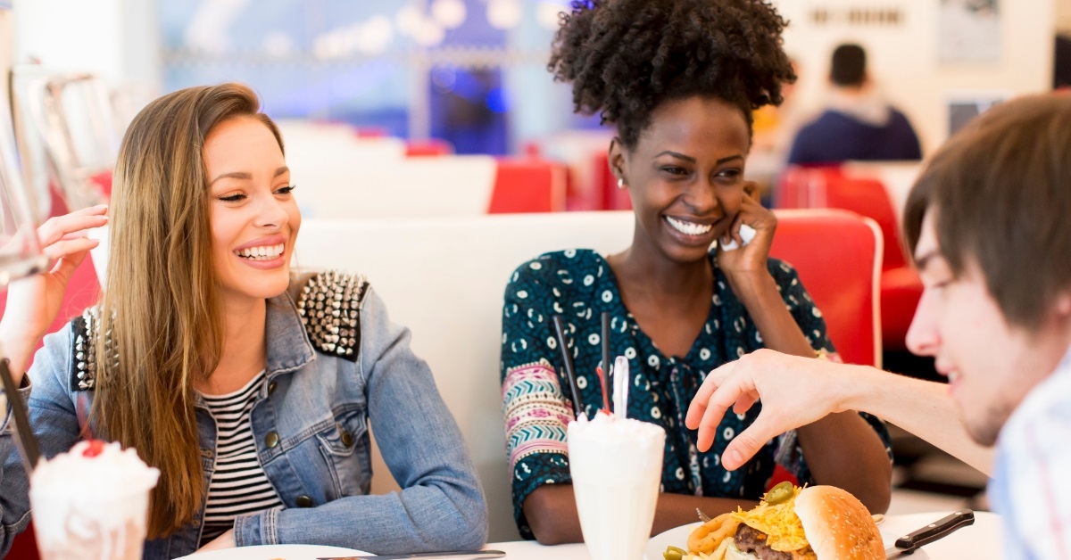 multi ethnic friends at restaurant