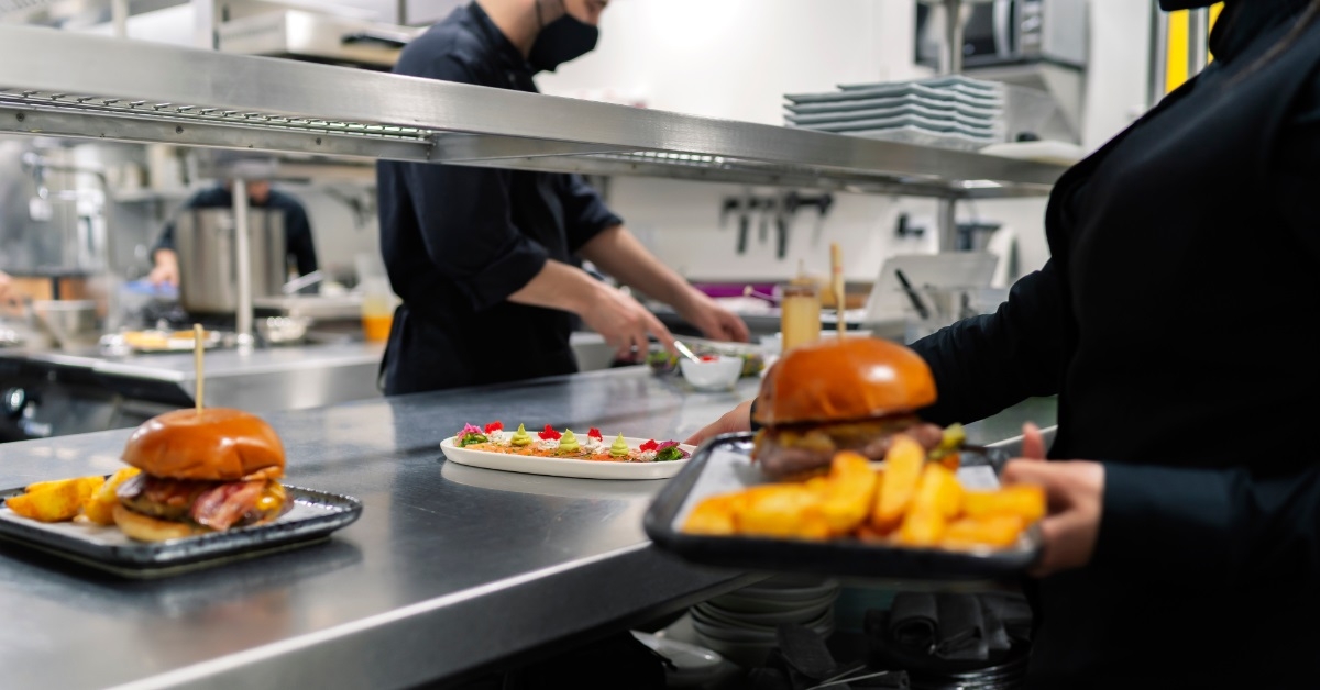 waitress taking fresh burgers to serve