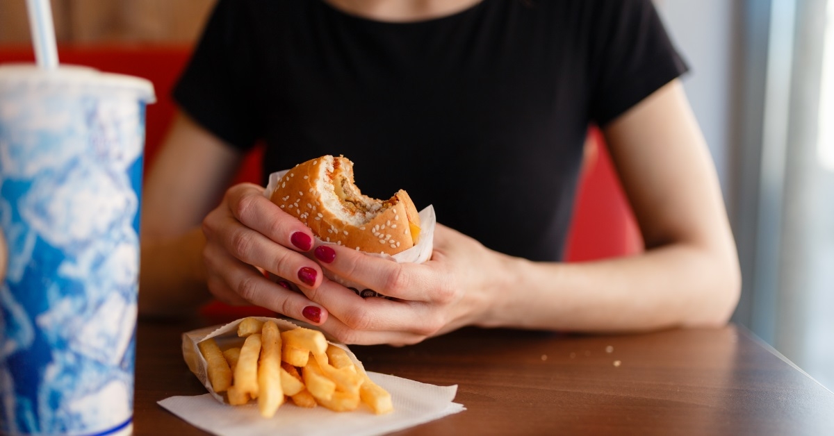 woman holding burger in hands