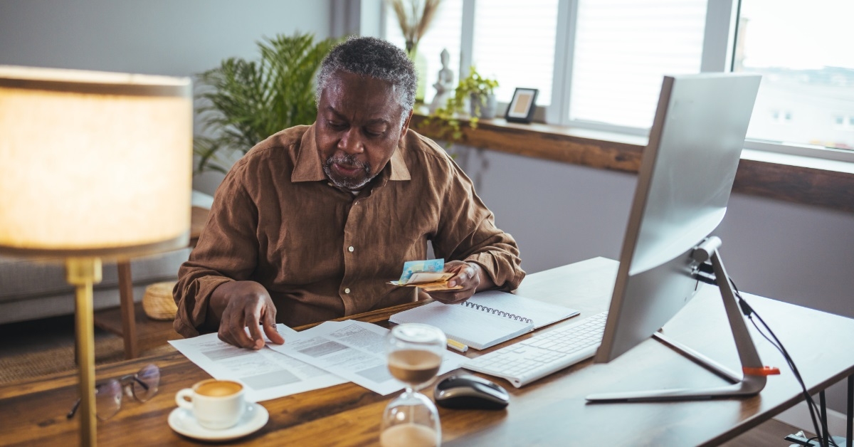 african american senior man reviewing bills