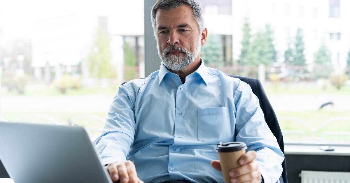 senior businessman using laptop at office