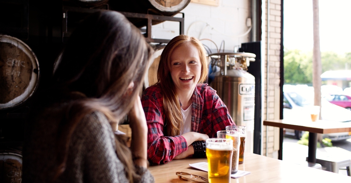 young women sitting in brewery
