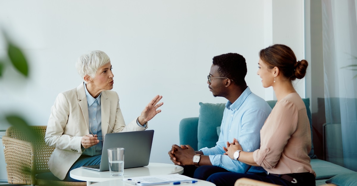 multi ethnic couple consulting finance advisor