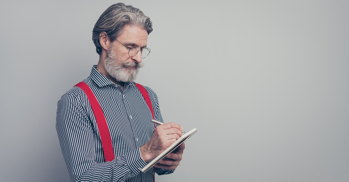 man writing notes planning schedule