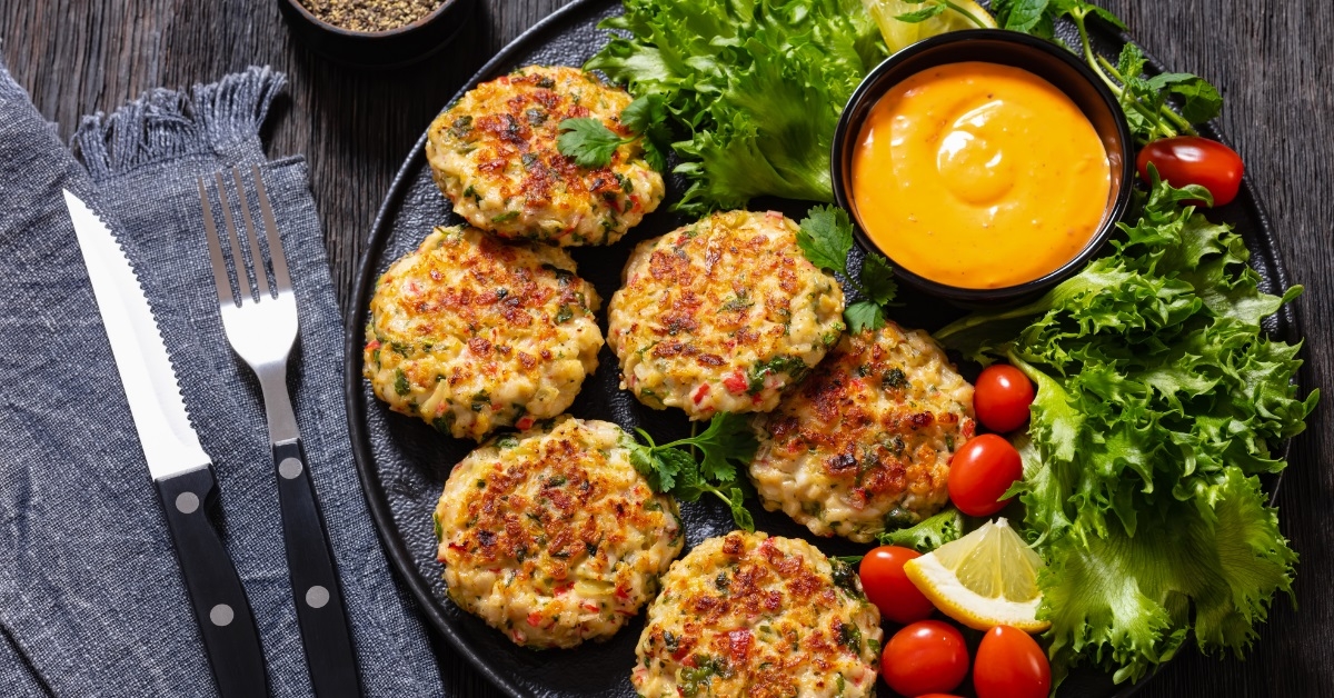 crab cakes with sauce and salad