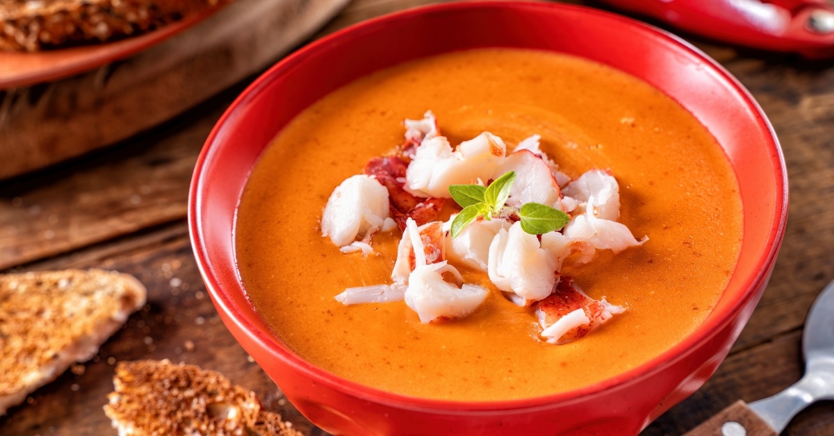 creamy lobster bisque bowl on table