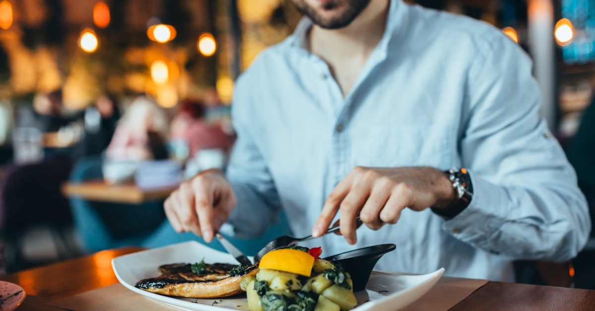 happy man having lunch in restaurant