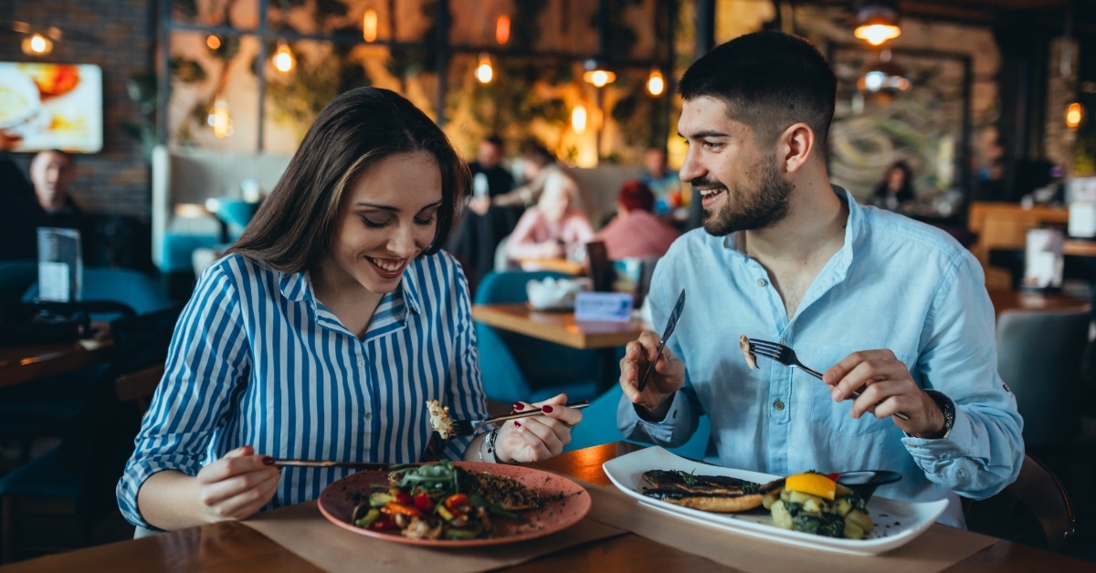romantic couple eating out at restaurant