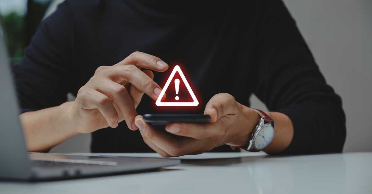using smartphone with warning sign