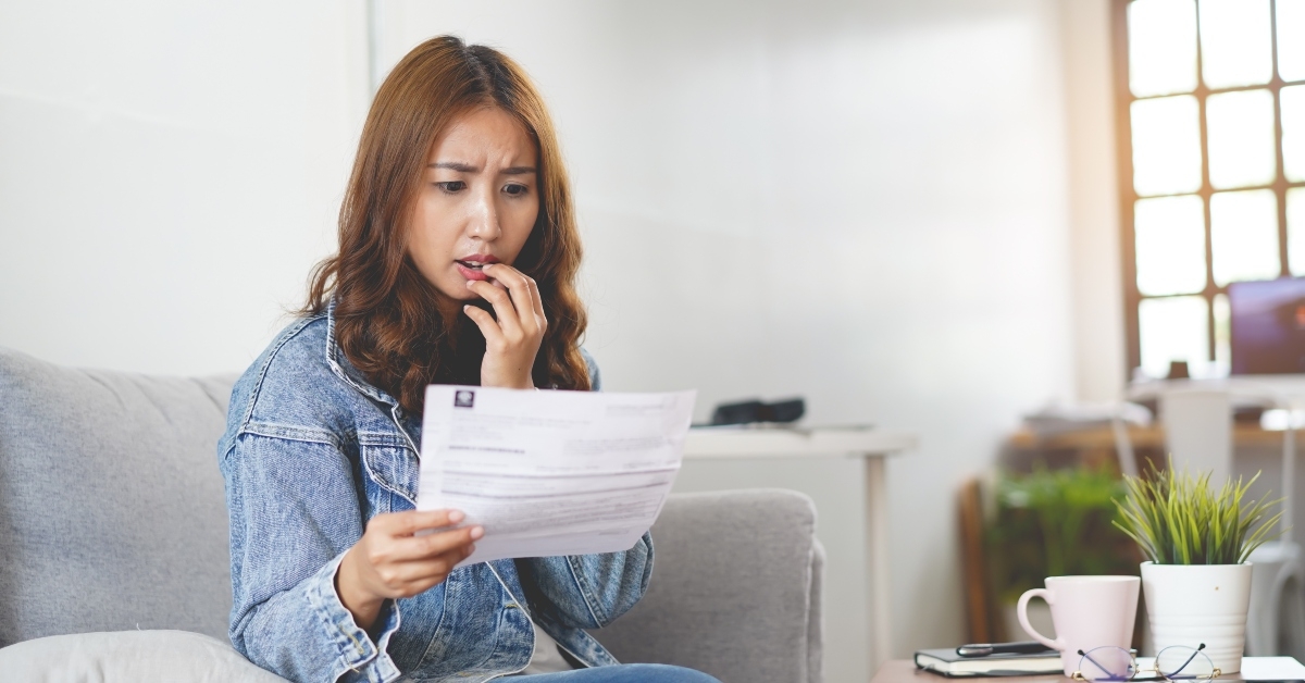 shocked asian looking at expenses
