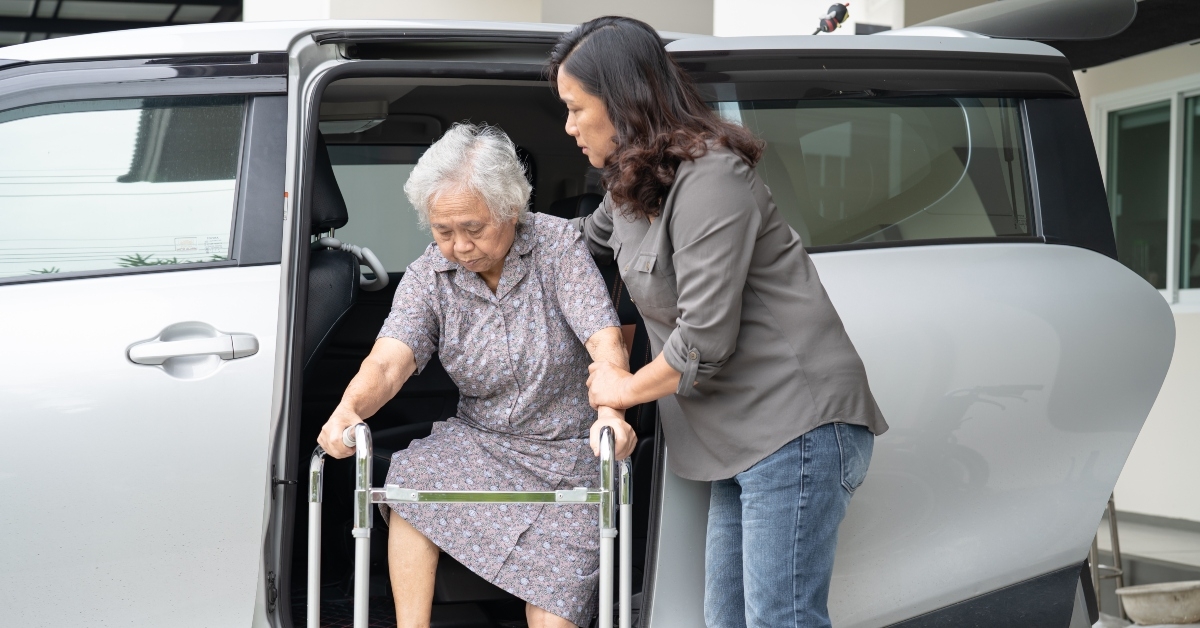 caregiver supports asian senior