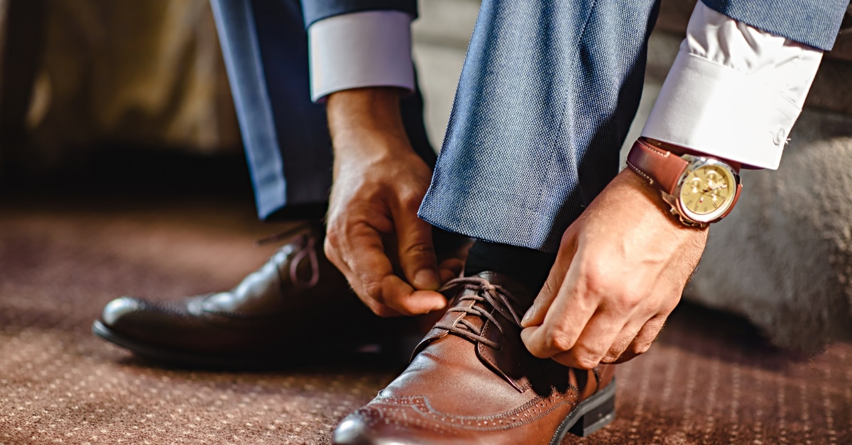 businessman tying shoe laces