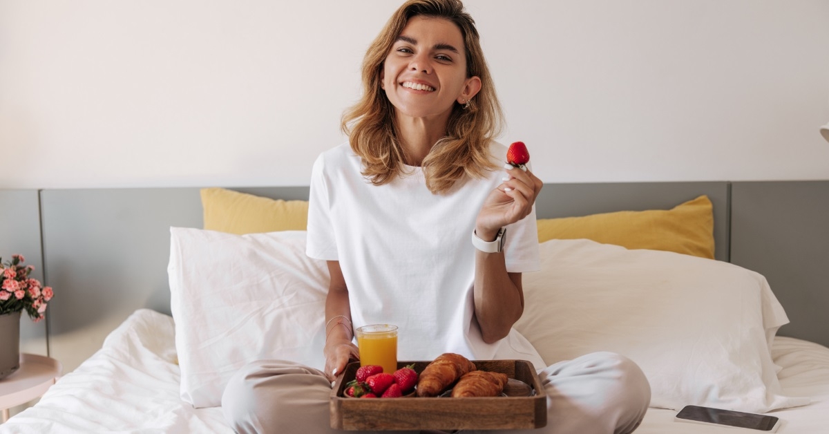 woman in bed with breakfast tray