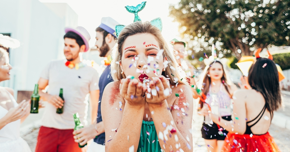 woman blowing confetti