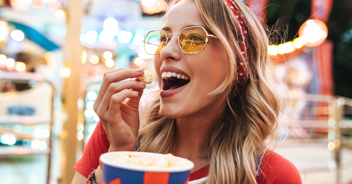 woman rejoicing and holding popcorn