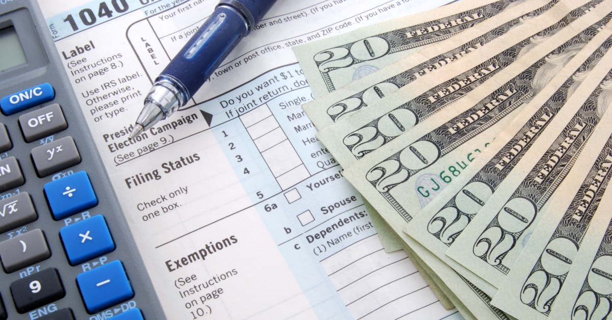 dollar bills over tax form