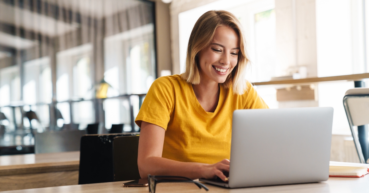 joyful woman using laptop