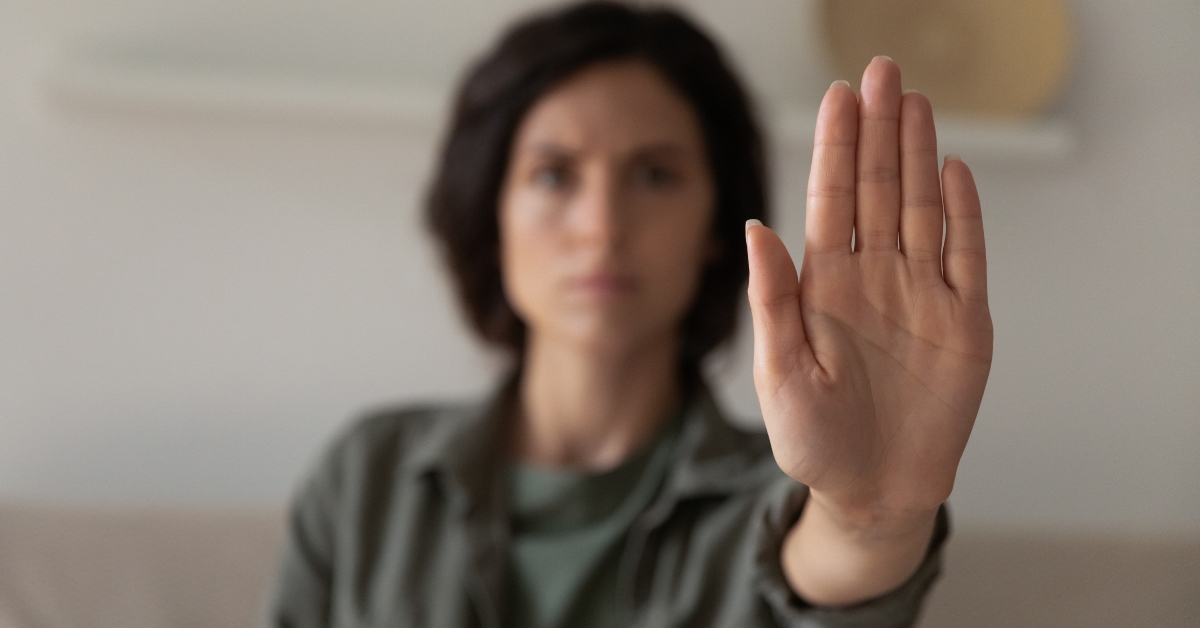 extending hand forward saying no 