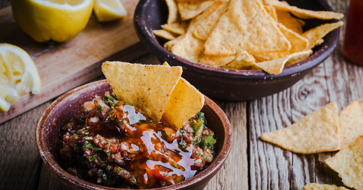 salsa and tortilla chips on table