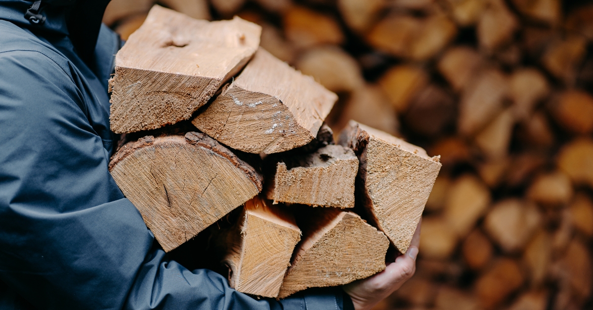 man carries heap of wood