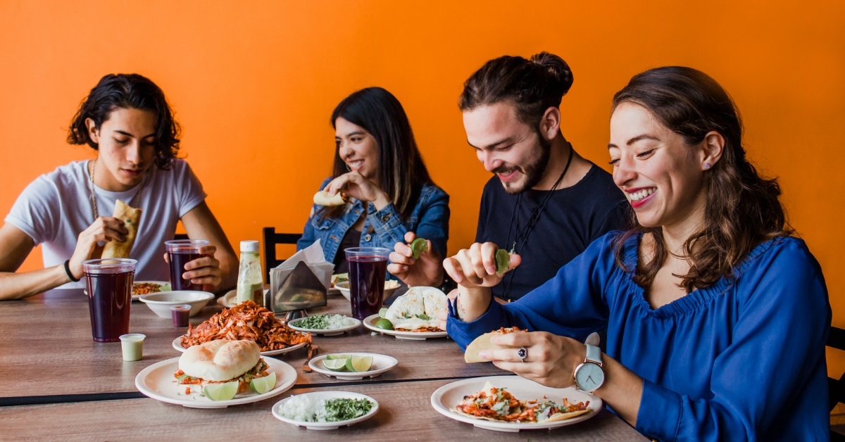 mexican people eating taco al pastor