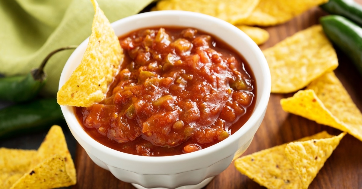 Red tomato spicy salsa with chips