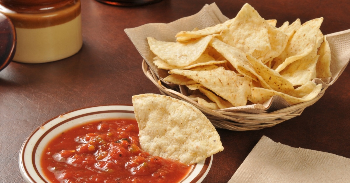 Tortilla chips on plate with salsa 