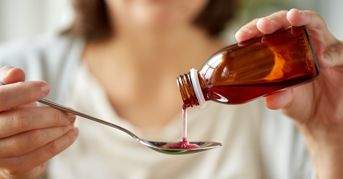 woman pouring medicated syrup to spoon