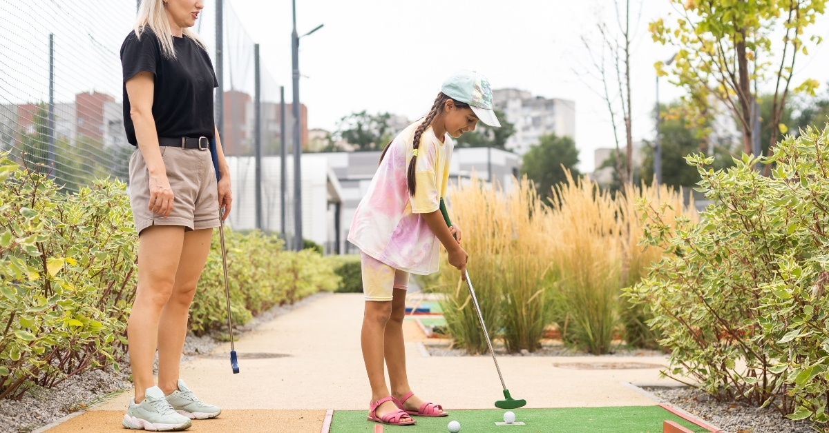 mother and daughter playing mini golf
