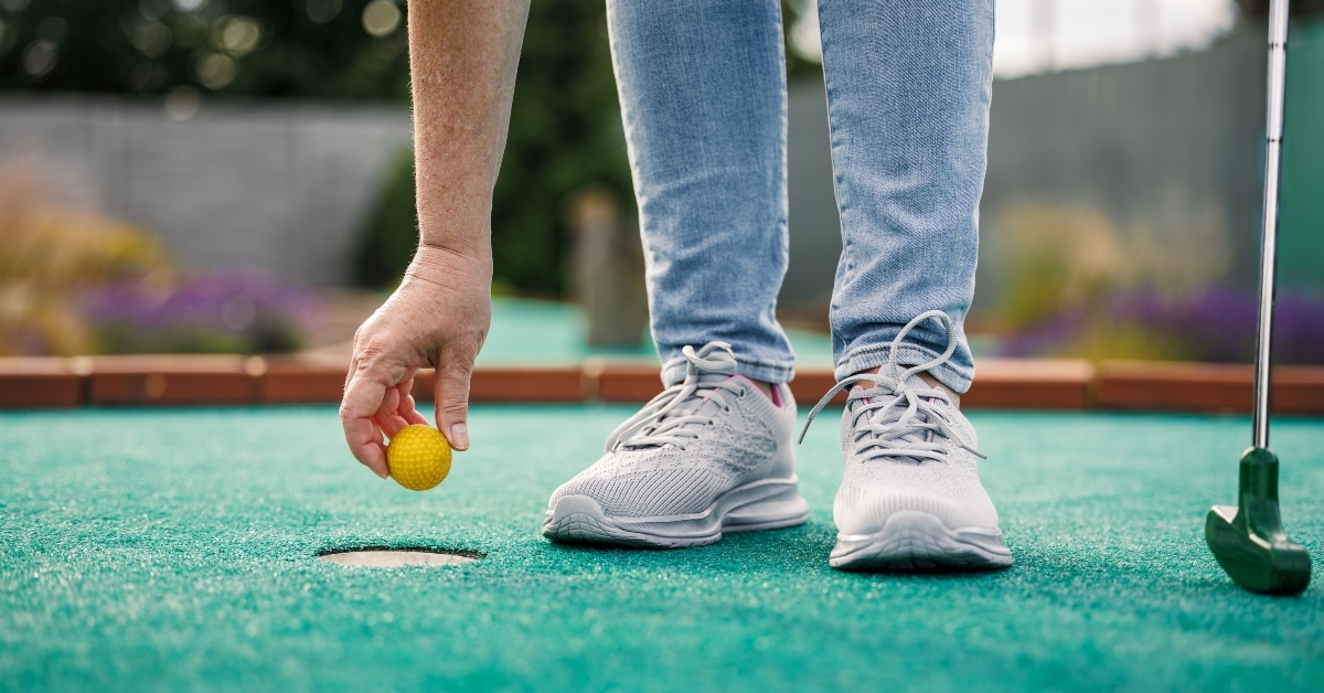 woman plays mini golf