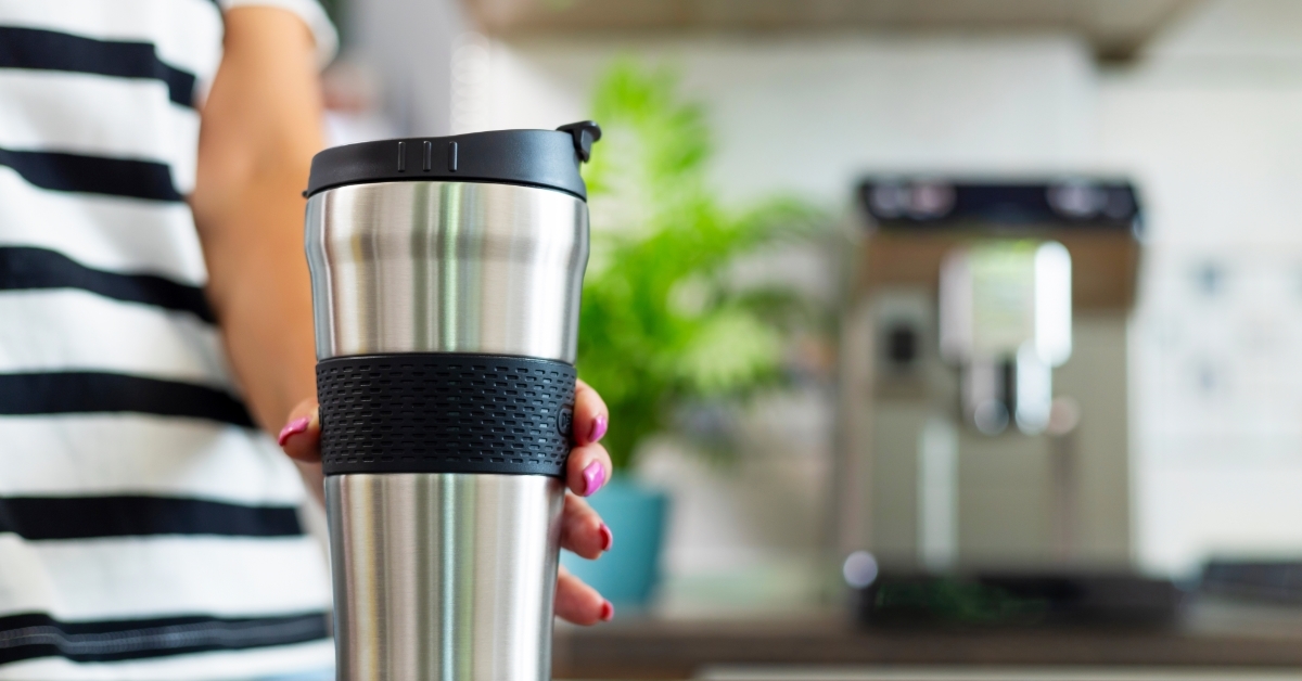 Hand Holding Stainless Steel Travel Mug