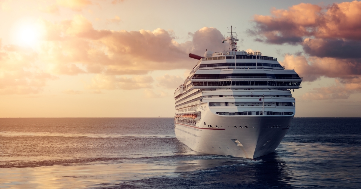 Luxury cruise ship cruising at sunset