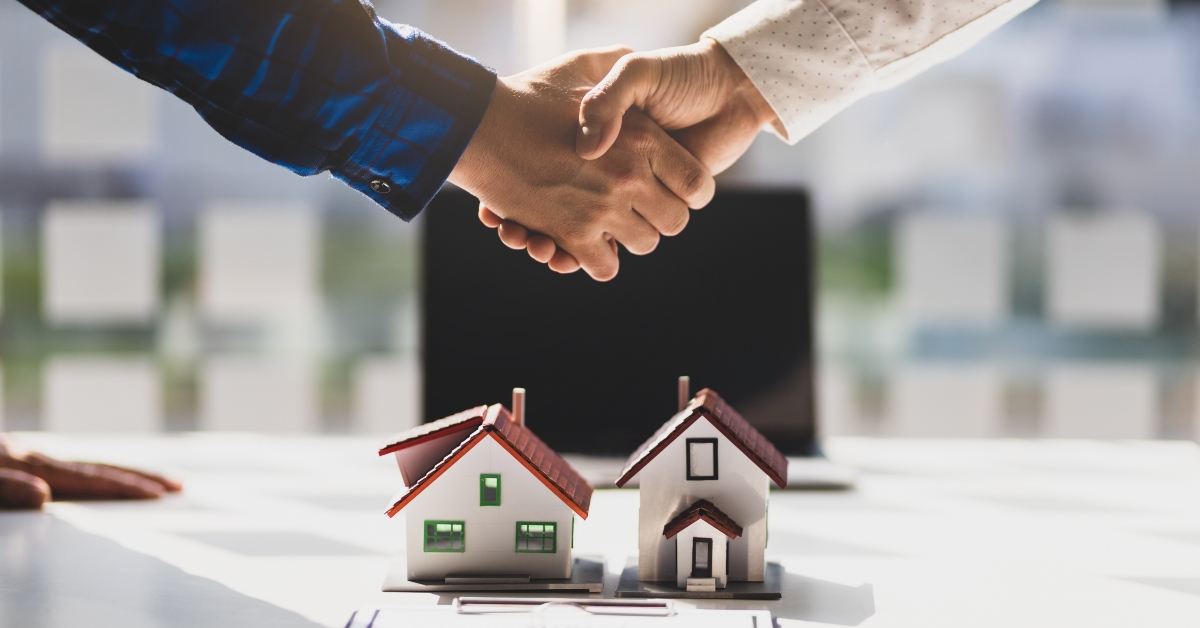 real estate agents shake hands