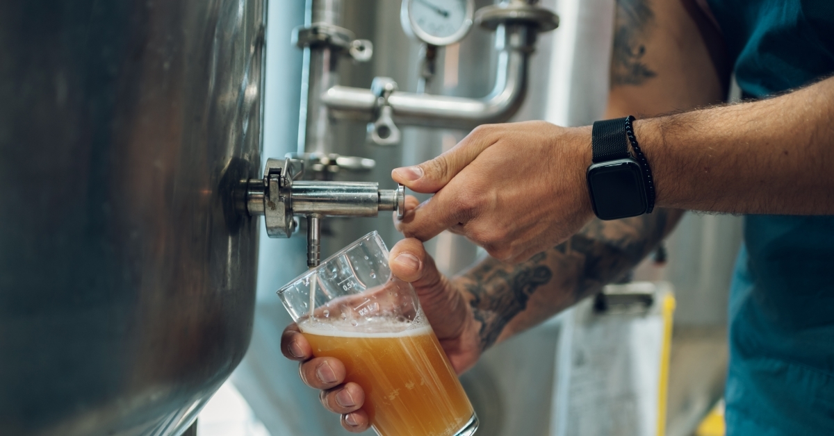 brewer filling glass of beer