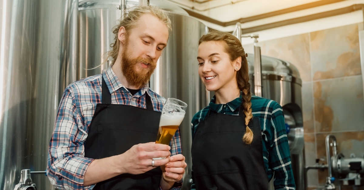 brewers checking beer at distillery