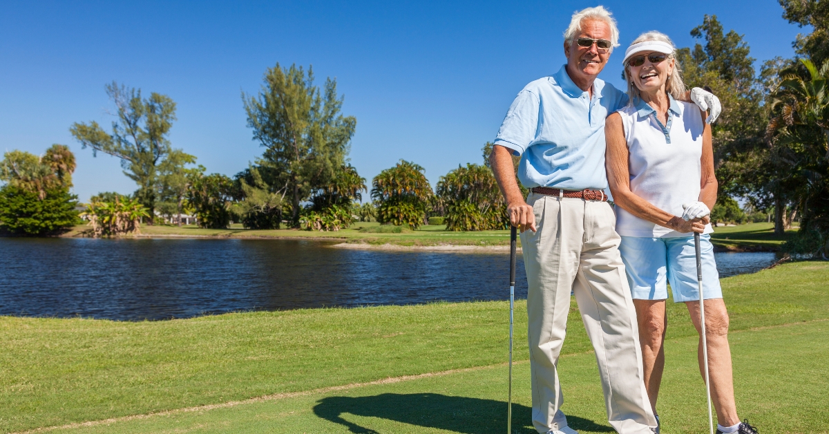 happy senior couple playing golf