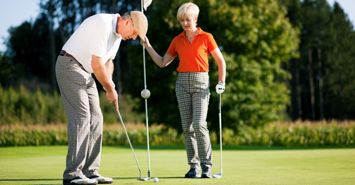 mature couple playing golf