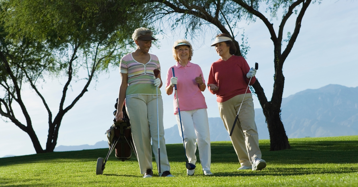 women walking on golf course