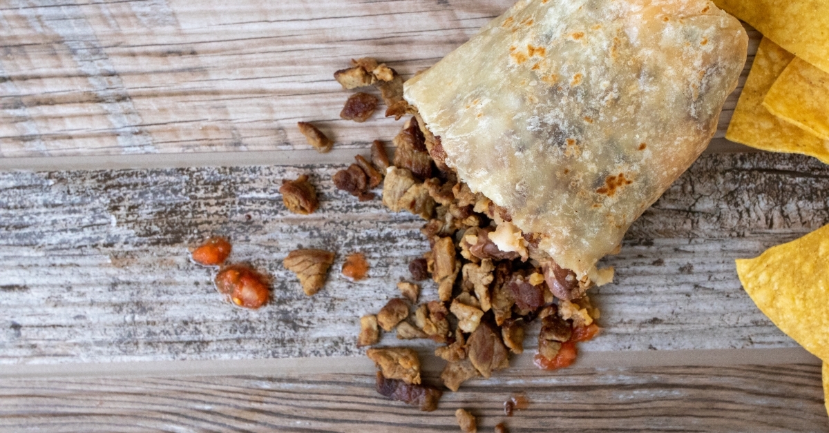 carne asada burrito spilled on table