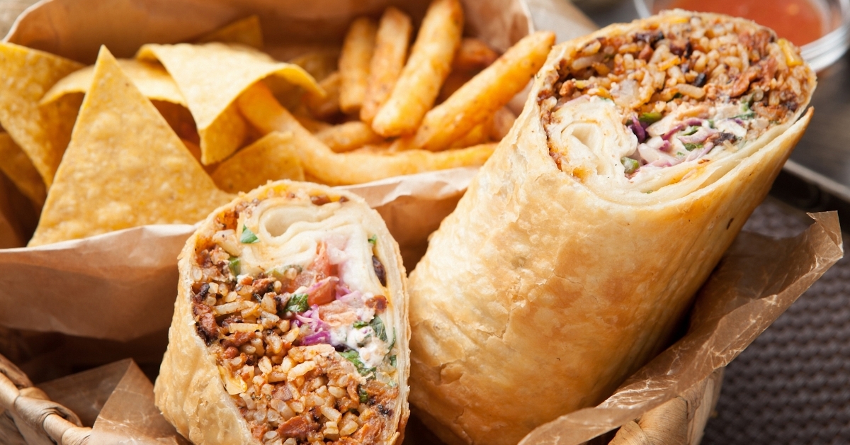 half burritos beside fries tray