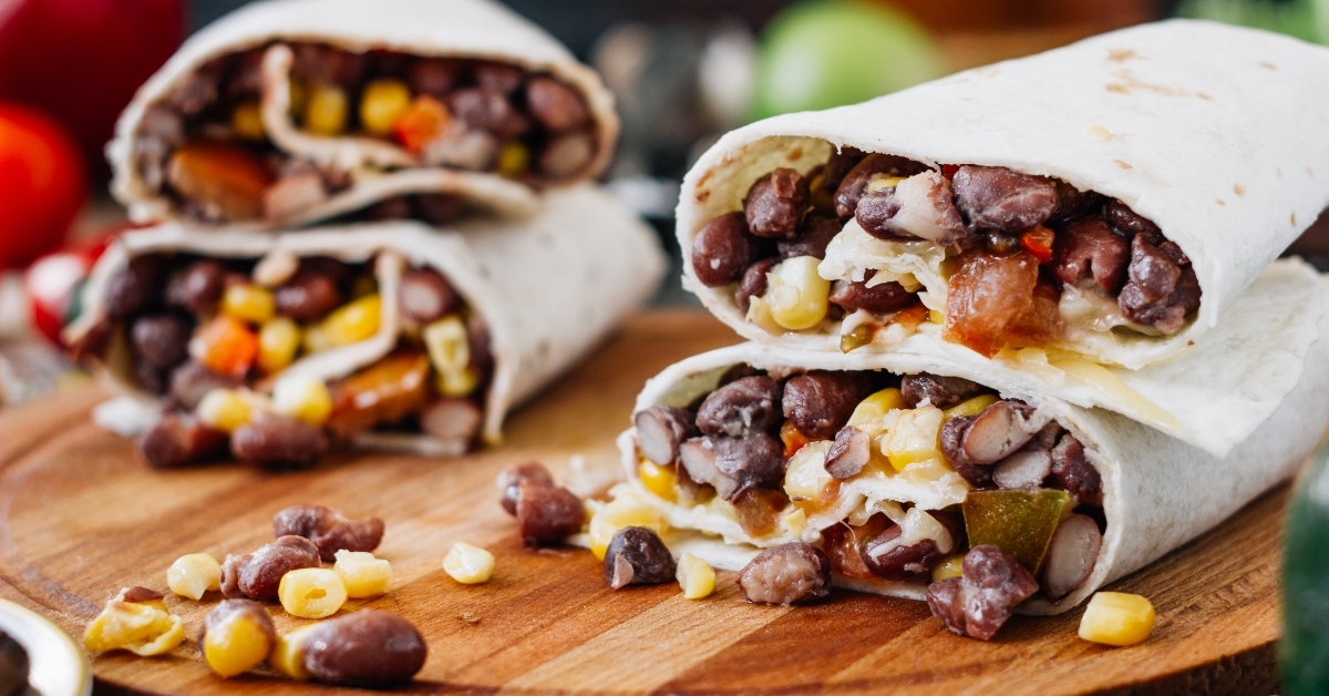vegetarian burrito on wooden board