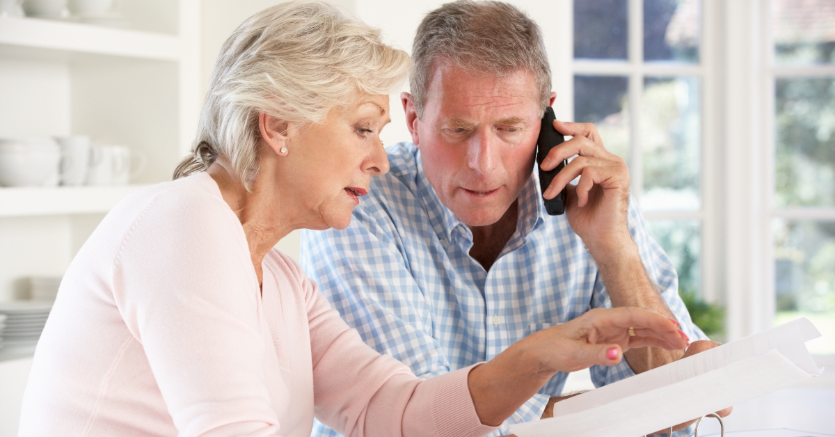 retired couple with household bills