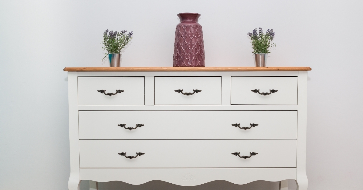 White wooden dresser with vases