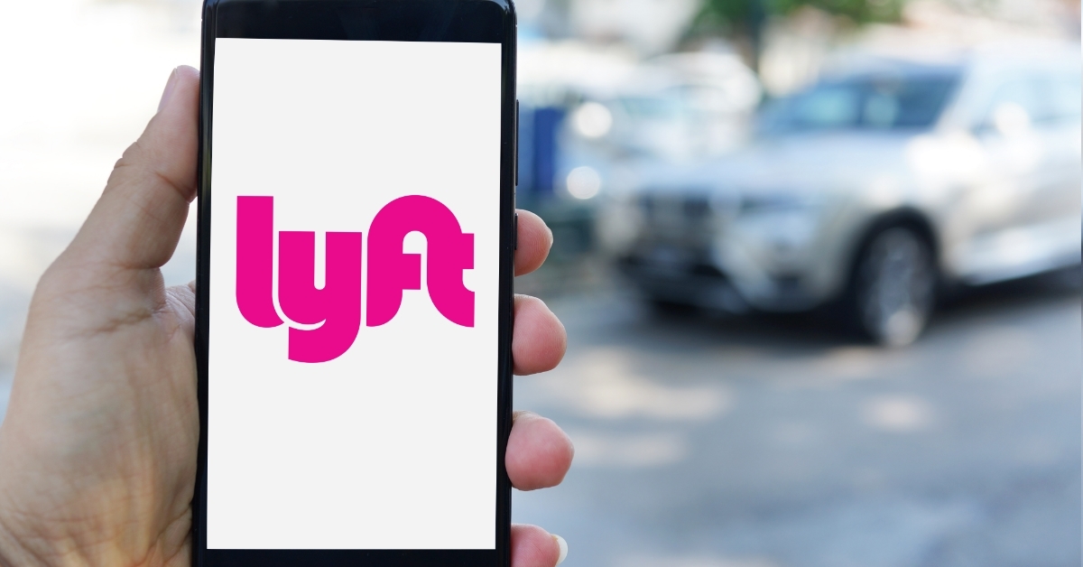 man using Lyft app on smartphone