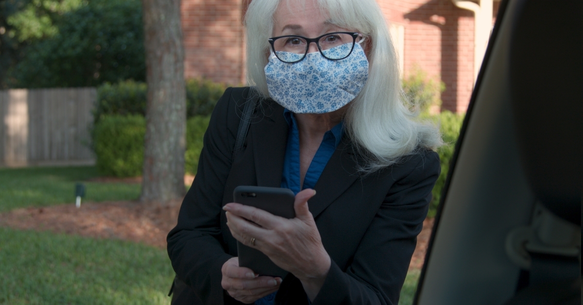 senior woman using uber service app