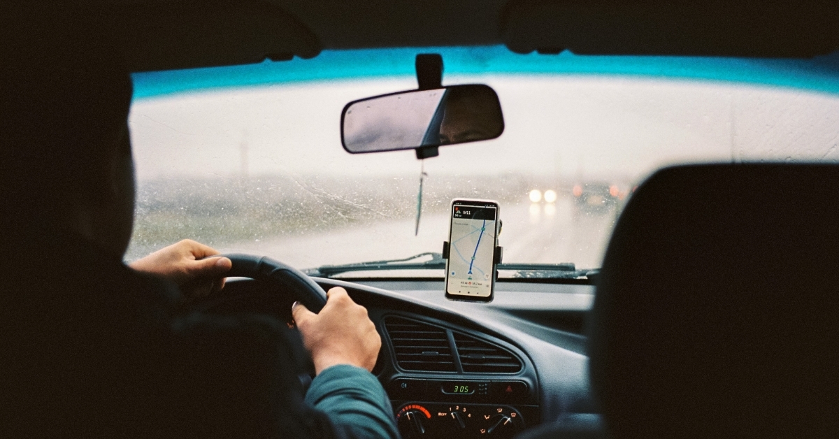 uber driver driving car with gps