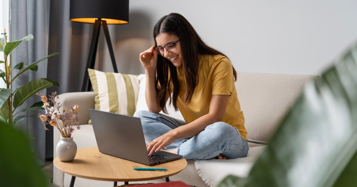 happy female student studying using laptop