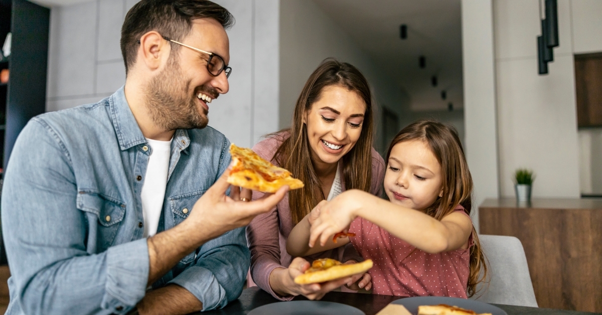 happy family eating pizza at home
